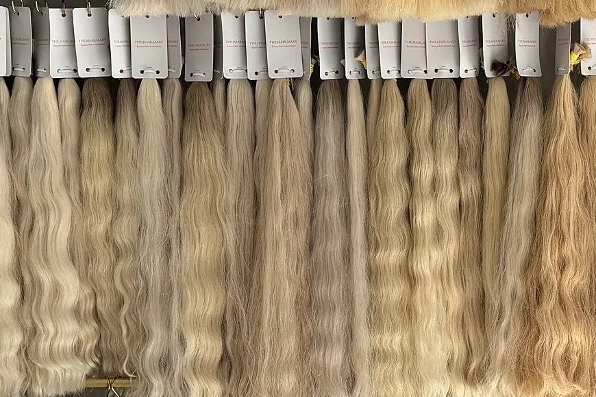 A row of wavy Slavic hair bundles in blonde shades